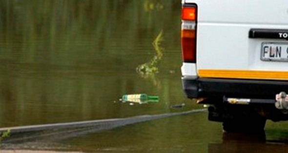 Angry tourist tossed his bottle in the KNP river, amongst wildlife.